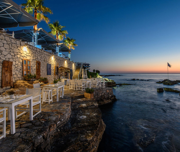 Cretan Blue Beach Hotel restaurant by the sea for dinner under the blue and red sky
